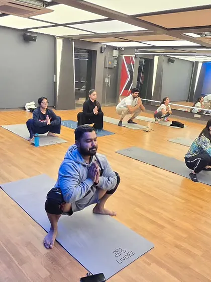 Students in Malasana (Garland Pose). This deep squat improves digestion, strengthens the lower body, and is excellent for activating the pelvic floor.