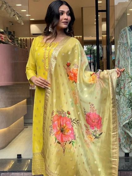 A mustard viscose organza kurta with jacquard woven details. The printed dupatta adds a modern touch to this traditional fabric.