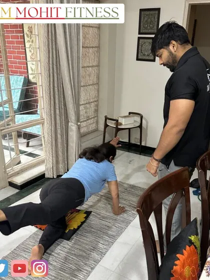 A client doing a bird-dog exercise on a yoga mat at home. This is an excellent exercise for improving core stability and balance.