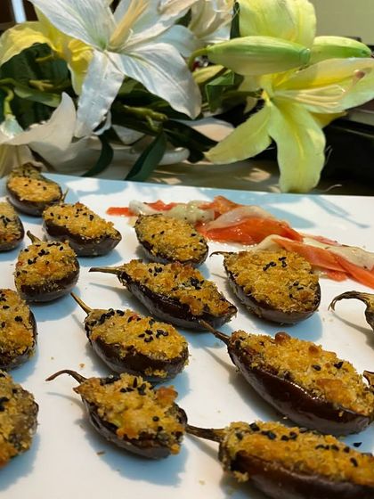 Stuffed jalapeños, baked to perfection with a cheesy, crispy topping. These offer a delightful combination of spice and creaminess, perfect for those who like a little kick.