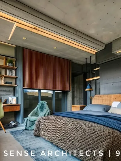 This bedroom showcases a modern, industrial aesthetic with exposed concrete ceilings and warm wood accents. We designed this space in a Pioneer Araya apartment to be a functional retreat, complete with a built-in desk, ample shelving, and layered lighting to create a cozy yet sophisticated atmosphere.