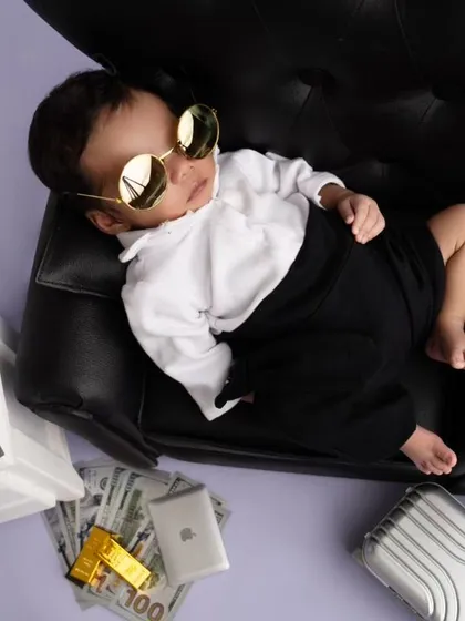 The Boss Baby is ready for business, even while napping, with a cool pair of gold sunglasses.