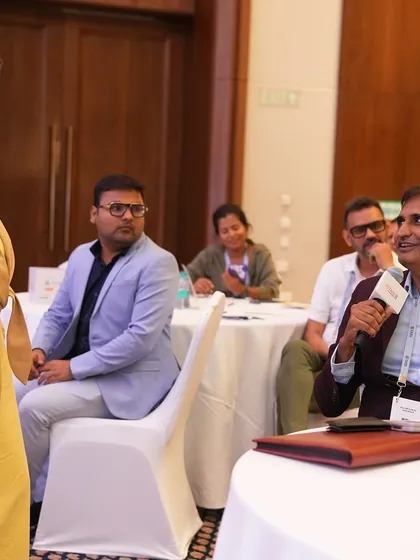 Interactive Q&A sessions are where theory meets practice. An educator stands to ask a question during my workshop, allowing us to dive deeper into the real world application of parenting and teaching strategies.