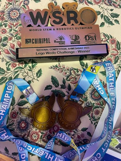 Visual aids are a key component of the Communication Skills exam. These medals and trophies from a robotics competition serve as a powerful visual aid for a student's speech, providing clarity and engagement.