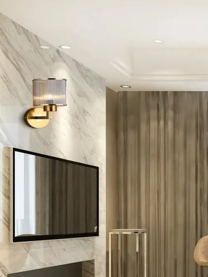 This gazzy glass metal wall lamp has a textured glass shade and an antique finish. It provides a soft, ambient light that is perfect for creating a cozy and inviting atmosphere next to a TV or in a reading nook.