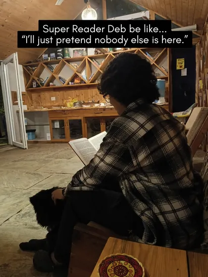 A participant finds their focus zone, completely absorbed in a book with a furry companion nearby. This is what we mean by distraction-free reading.