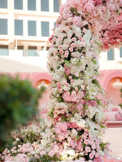 A close-up of the floral pillars of the 'Echoes of Pink' mandap. Each flower is unique, yet together they create a harmonious design, much like the families coming together to celebrate.