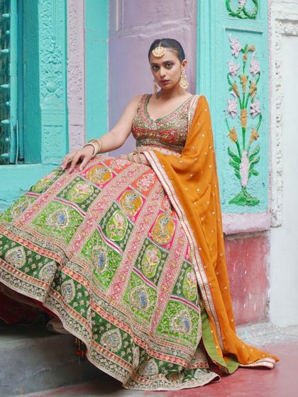 This multi-panelled lehenga is fit for royalty. With its vibrant colors and detailed embroidery, it’s a unique and unforgettable choice for a bride.
