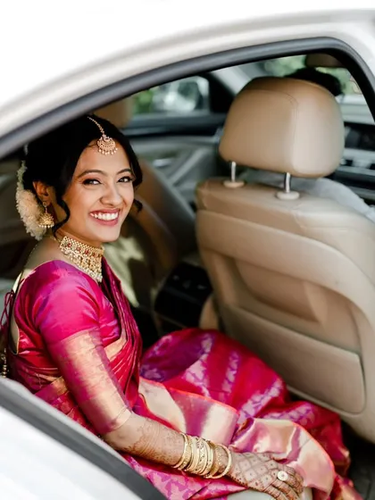 A series of photos capturing the grace of this South Indian bride. Her look features traditional temple jewelry, a silk saree, and a fresh, dewy makeup finish with a classic floral hair bun, embodying timeless elegance.