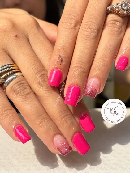 A bright and fun pink manicure. This set combines solid hot pink nails with an accent nail featuring a sparkling pink glitter ombré fade.