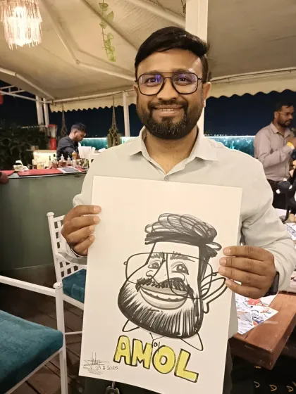 A guest named Amol with his caricature at a get-together at Sky Lounge.