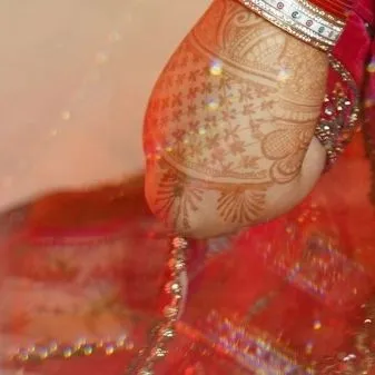 A macro shot of the intricate mehndi design on the bride's arm. We appreciate and document the artistry of every element of your wedding.