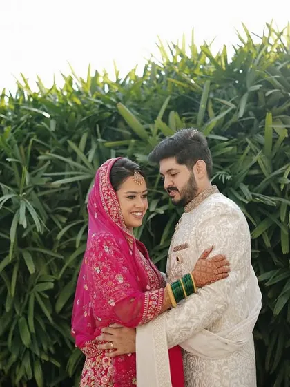 A quiet moment together amidst lush greenery. This portrait showcases the couple's connection in a natural and serene setting.