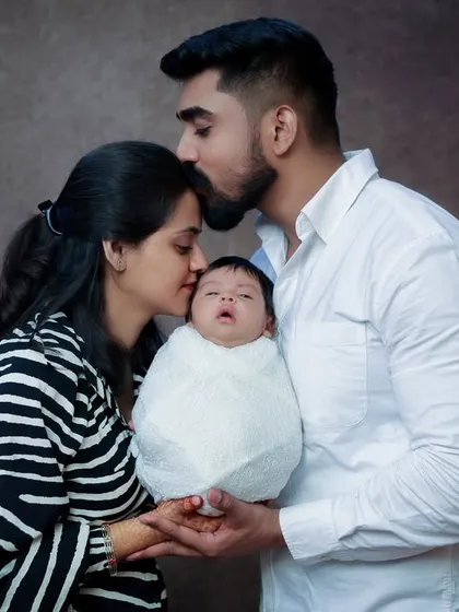 The moment a father kisses his wife's forehead while she holds their newborn is pure magic. It’s a candid expression of love and partnership as they begin their journey as a family of three.