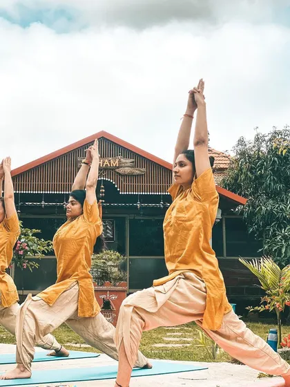 We take our practice into the embrace of nature whenever we can. Here, I am leading a class in Virabhadrasana I (Warrior I Pose) in the ashram garden. Practicing outdoors reminds us that we are part of something larger than ourselves, grounding our energy and strengthening our spirit.
