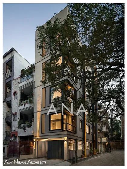 The corner of the Yellow Line Apartment building, where the front and side facades meet. The design uses large corner windows to open up the interior living spaces to the exterior.