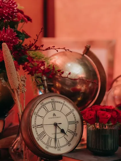 An antique globe and clock add to the old-world charm of the sangeet decor.