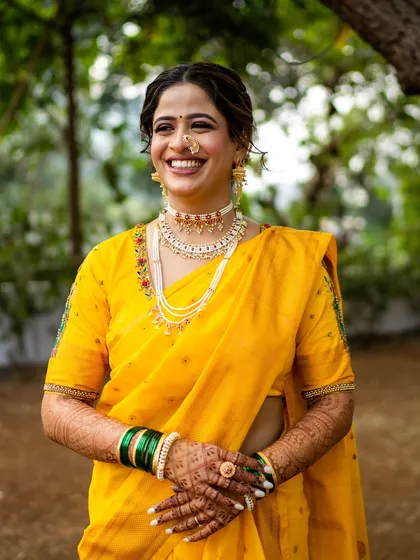 A joyful, candid moment. Her makeup is designed to look beautiful from every angle, capturing her radiant smile and the happiness of the day.