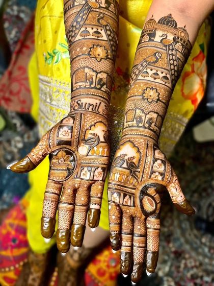 The completed personalized mehandi, showing the name 'Sunil' beautifully integrated with birds, elephants, and other classic elements.