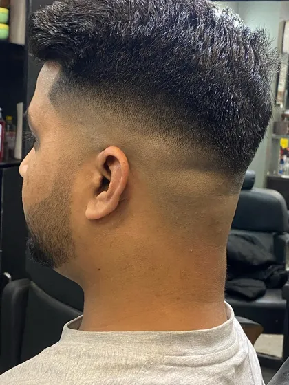 A clean skin fade from the back. This type of fade requires careful blending to avoid any harsh lines, resulting in a smooth finish.