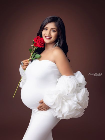 Adding a simple prop like a single red rose can introduce a touch of color and symbolism to your portraits, representing love and new beginnings.