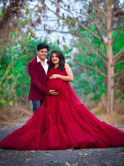 This vibrant red ball gown creates a striking image in a natural, wooded setting. It's a wonderful choice for couples wanting a bold and romantic photoshoot.