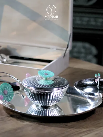 A close-up of the lidded silver bowl from our Daisy Collection. The intricate fluting on the bowl and the delicate, colorful daisy on the lid showcase our commitment to fine craftsmanship.