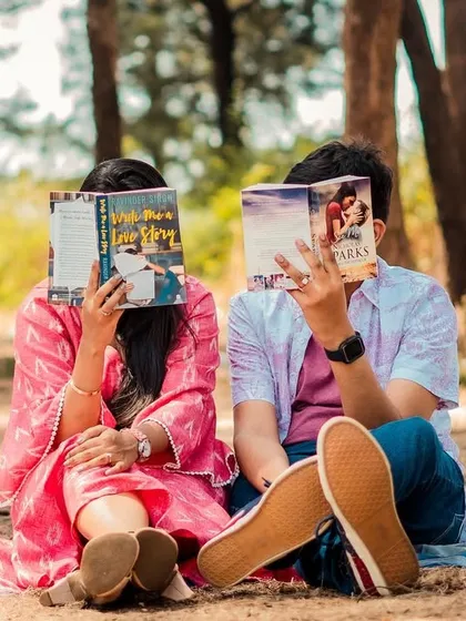 A playful shot of the couple hiding behind their books, a fun and creative idea for a themed session.
