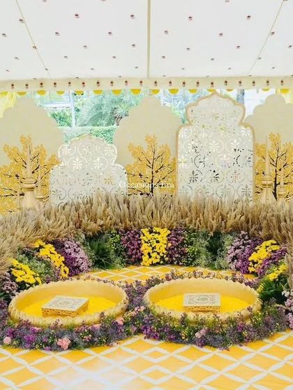 A beautiful Haldi or Mehendi ceremony setup. We used fragrant pampas grass, yellow florals, and intricate cutout backdrops to create a sunny and joyful space for pre-wedding rituals.