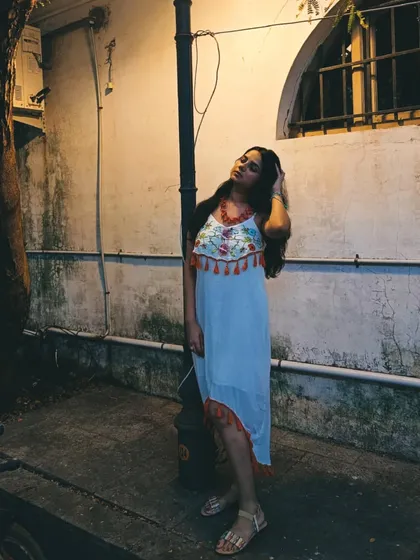 This dress even works for a nighttime stroll. The simple silhouette stands out against the evening light in the French Colony.