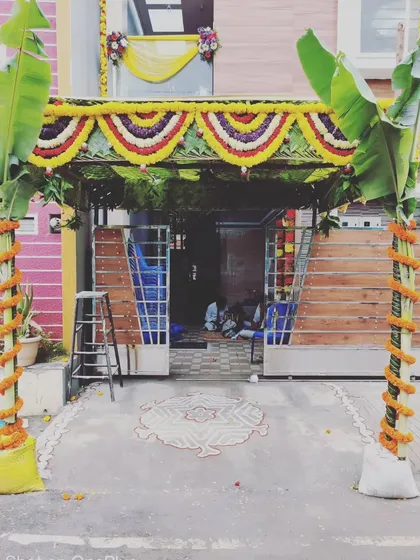 For a traditional housewarming, or Gruhapravesam, we create an authentic and auspicious entrance. This setup features a pandal made with coconut leaves, fresh banana plants, and marigold flower garlands for a truly blessed welcome.