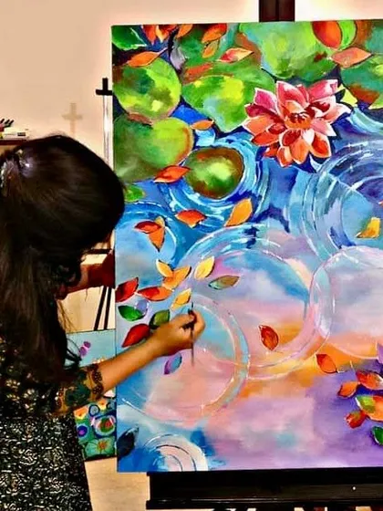 It's never too late to find your inner artist. This student is creating a beautiful, vibrant lotus pond painting, finding her moment of peace and focus in my adult art class.