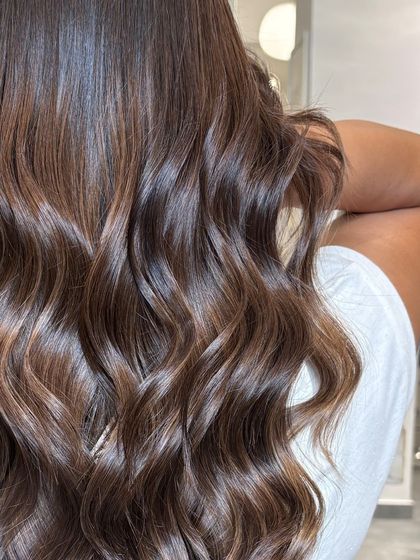 A detailed shot of the chocolate balayage, highlighting the glossy finish and the way the colors blend together flawlessly.