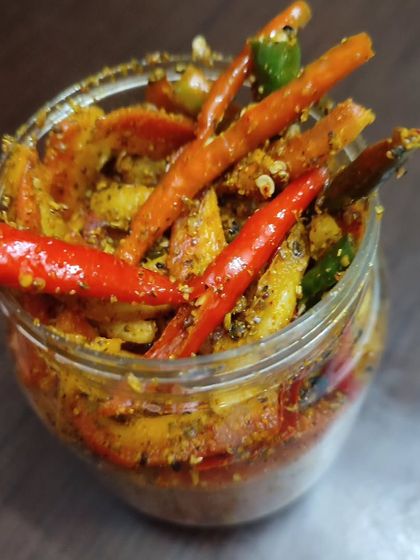 A jar of my special winter pickle, featuring carrots, turnips, and chillies. It's a seasonal favourite that brings warmth and flavour to your meals.