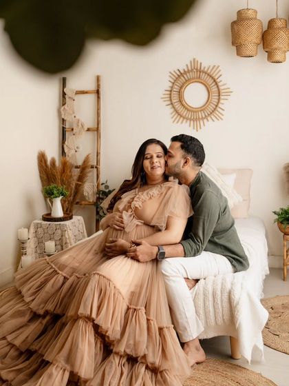 A sweet kiss for the mom-to-be. This candid moment was captured on the bed in my boho studio set. It feels so relaxed and intimate, like a little peek into their happy world.