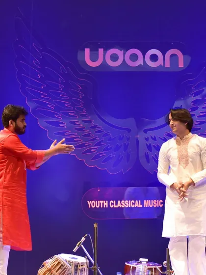 A gesture of respect and camaraderie on stage. This is the spirit of Indian classical music.