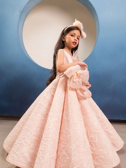 This side view shows the volume and structure of the pink brocade gown, fit for royalty.