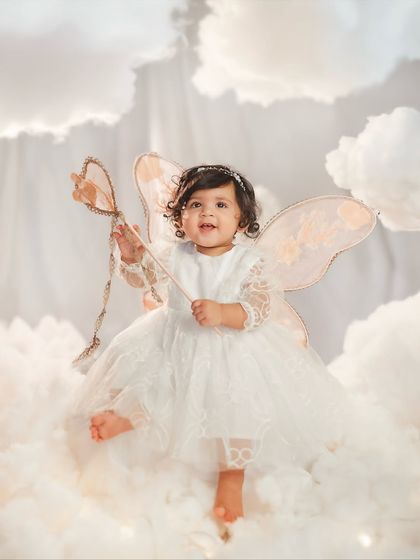 A little fairy with her magic wand. This "amidst the clouds" first birthday theme is one of my favorites for creating truly enchanting portraits.
