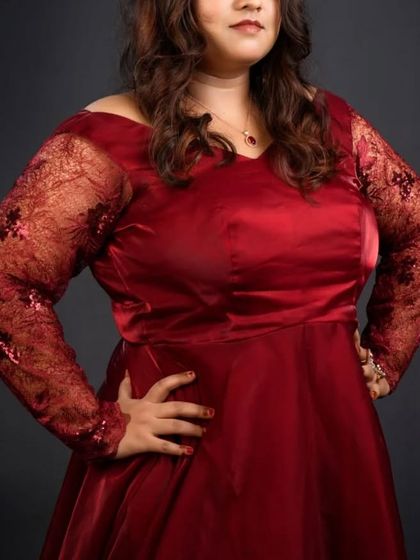 My outfits are size-inclusive. This beautiful red gown with lace sleeves is designed to flatter every body type and is available to rent or buy.