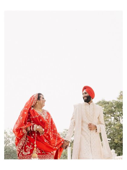 Kushmeet and Aishwarya share a happy moment, hand in hand. The high-key lighting and open space give this portrait a light, airy, and romantic feel.