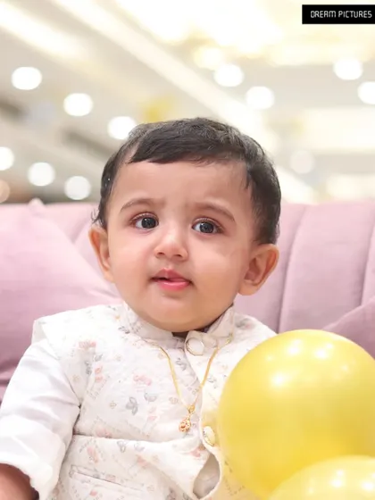 A close-up portrait of a baby boy at his party. My style is bright and clear, perfect for capturing the innocence of children.