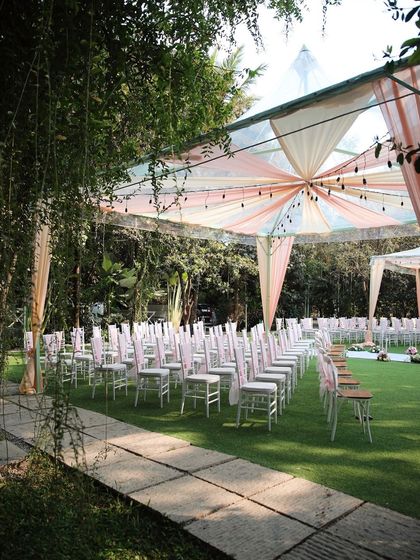 A collection of stunning wedding setups at The Farmhouse Collective. You can see the venue's versatility, from elegant morning ceremonies with floral mandaps to glamorous evening receptions with fairy lights and chic decor. This space is a blank canvas for your dream outdoor wedding in Bengaluru.