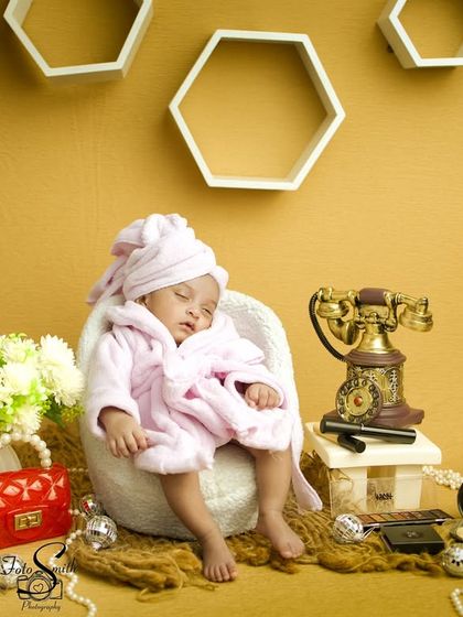 A sleeping beauty enjoying her spa day. This shot captures the peacefulness of the baby amidst the playful and glamorous props.