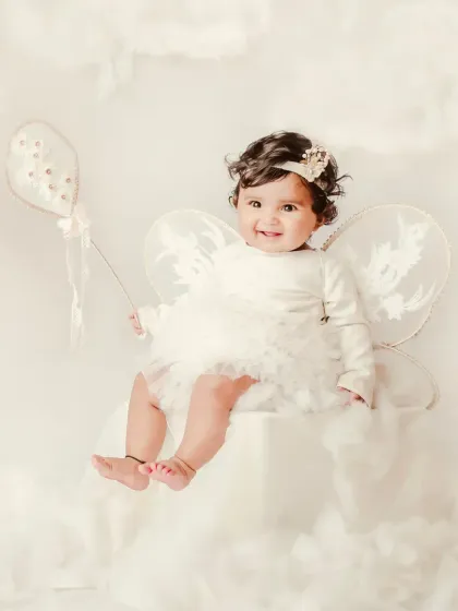 Floating on a cloud with a balloon in hand. This whimsical fairy-themed session is perfect for creating enchanting and imaginative portraits.