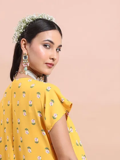 A profile shot that highlights the floral hair accessory and statement earrings. This shows my attention to detail in completing a festive look from head to toe.