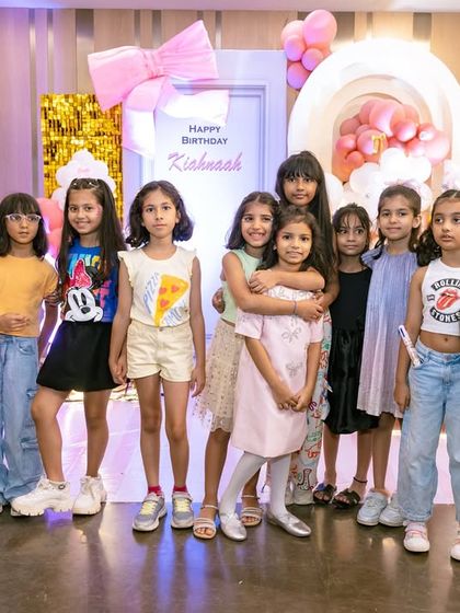 A group of friends posing for a photo at the party. My backdrops are always a popular spot for pictures.