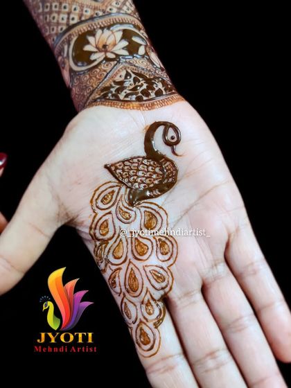 A single, elegant peacock motif on the palm. This is a perfect example of a simple yet beautiful design for any occasion.