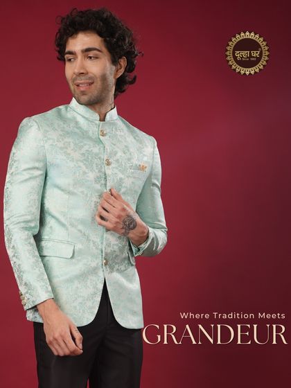 Where tradition meets grandeur. A model in a pastel blue brocade Bandhgala jacket, exuding a cool and sophisticated charm.