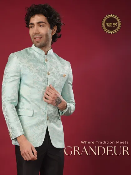 Where tradition meets grandeur. A model in a pastel blue brocade Bandhgala jacket, exuding a cool and sophisticated charm.