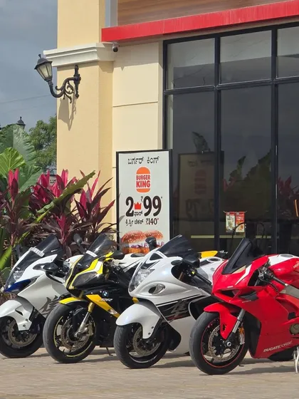 A colorful assembly of superbikes, including a Ducati, parked outside Burger King. It's a common sight to see riders gathering here for a break and a bite.